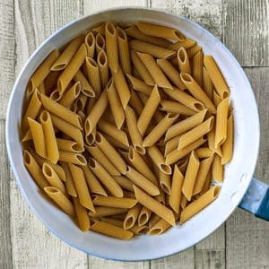 A saucepan full of penne pasta