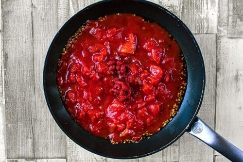 A tomato pasta sauce cooking in a frying pan