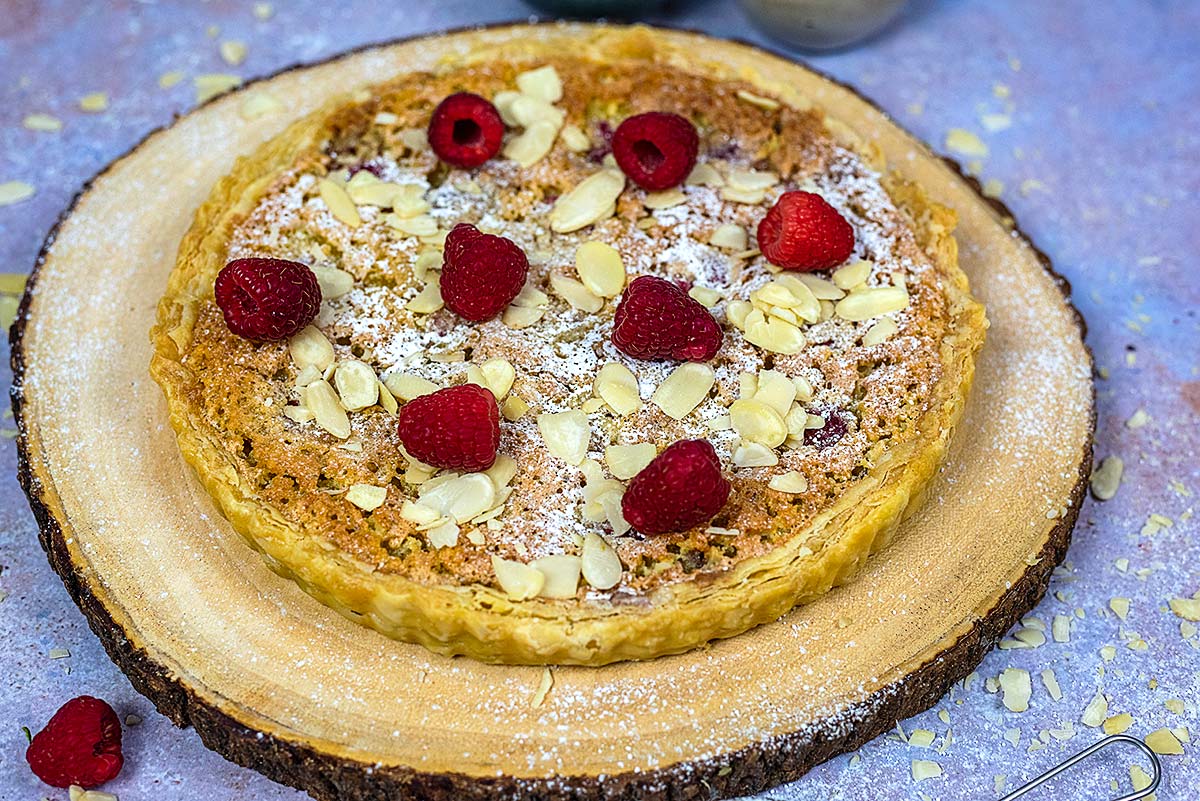 Bakewell pudding topped with raspberries and flaked almonds.