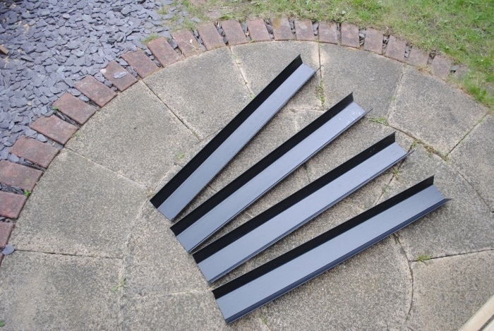 Black square line guttering cut into four lengths of one metre each