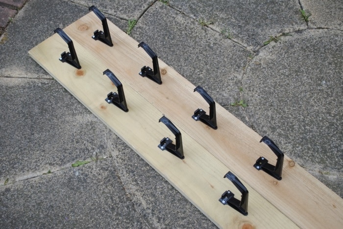 Two lengths of six by one timber with four gutter brackets screwed to each one.
