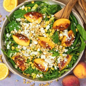 A large bowl of grilled peach salad.
