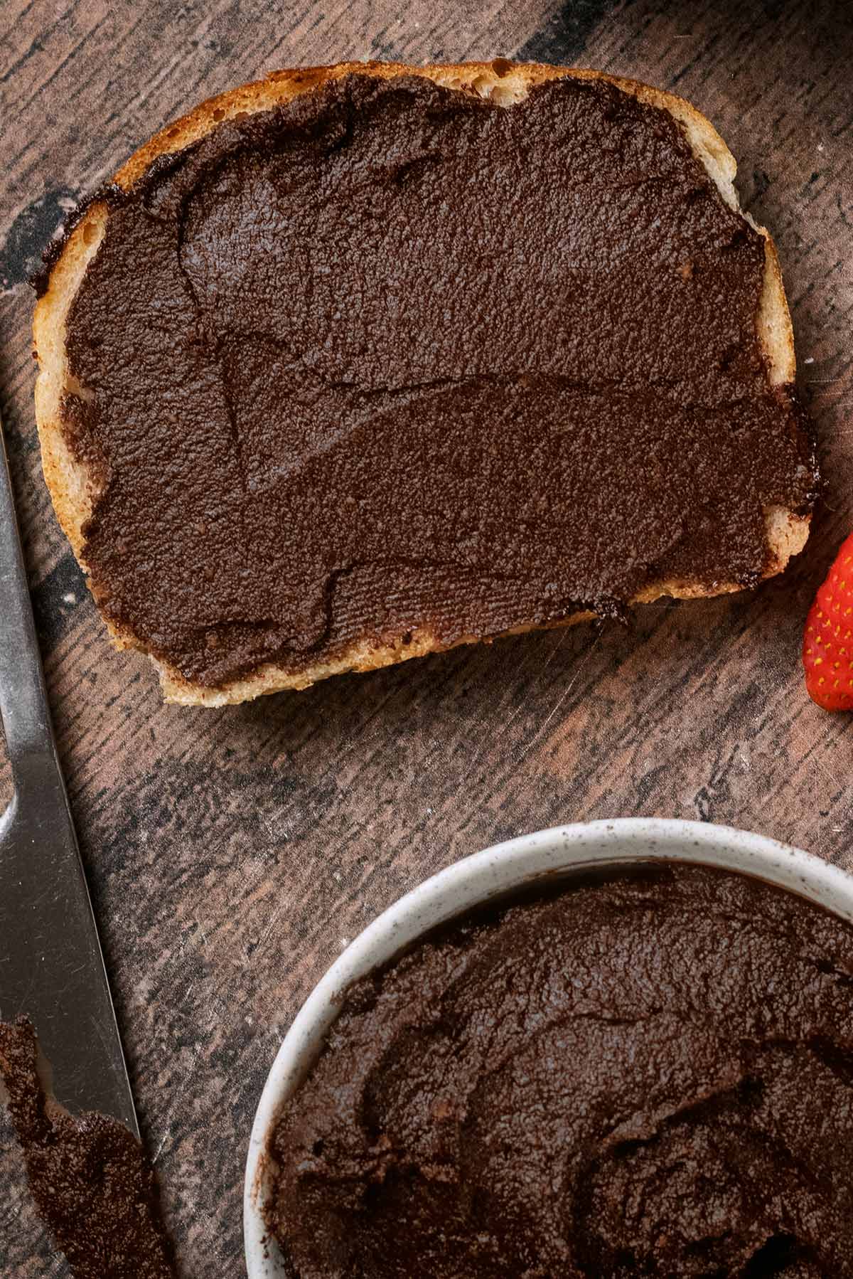 A slice of toast with chocolate spread on it.