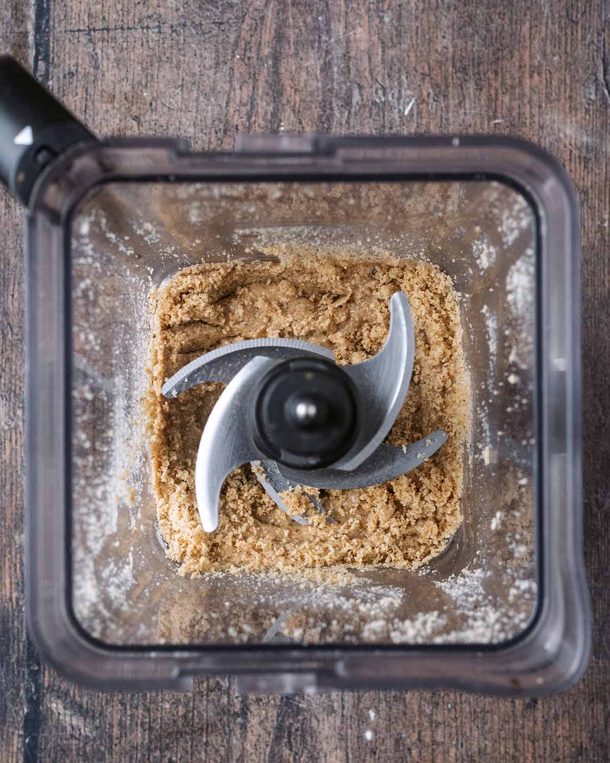 Blended hazelnuts in blender jug.