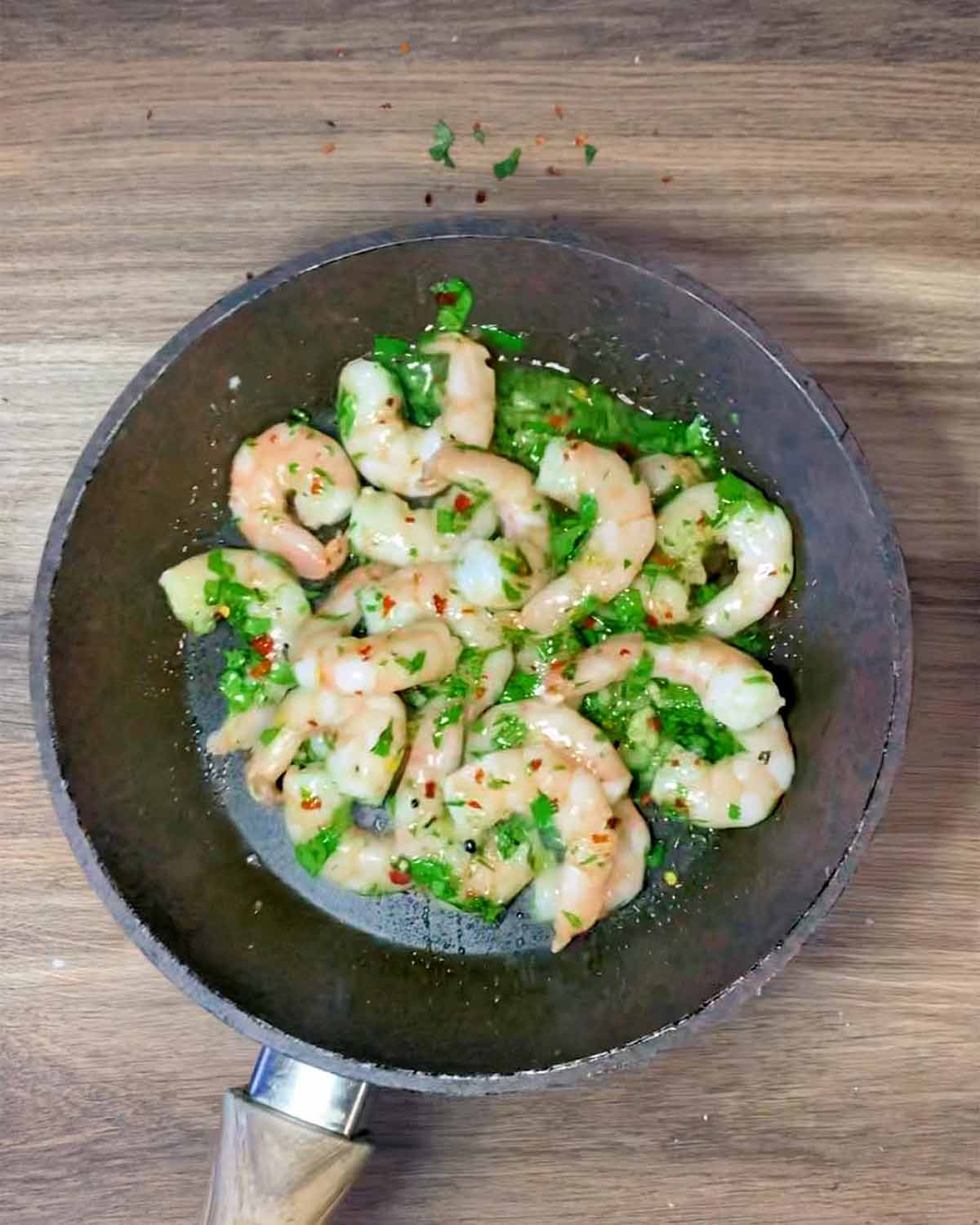 Prawns cooking in a frying pan.