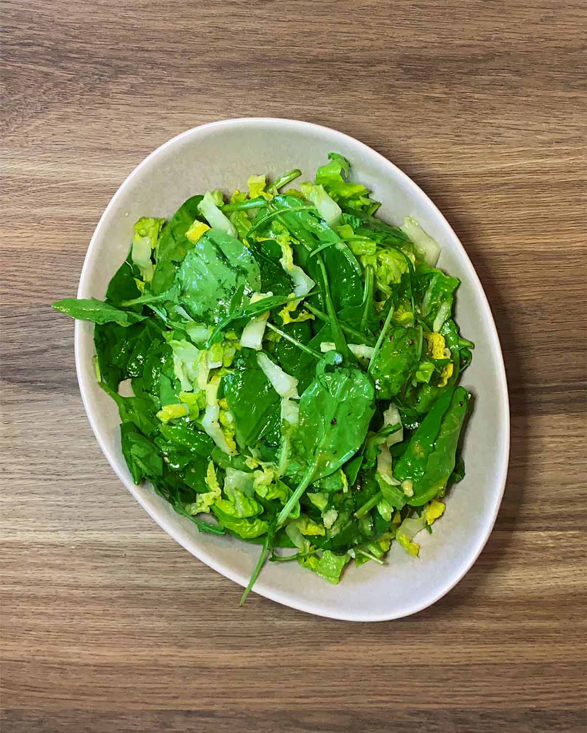 Salad leaves dressed in a lemon vinaigrette.