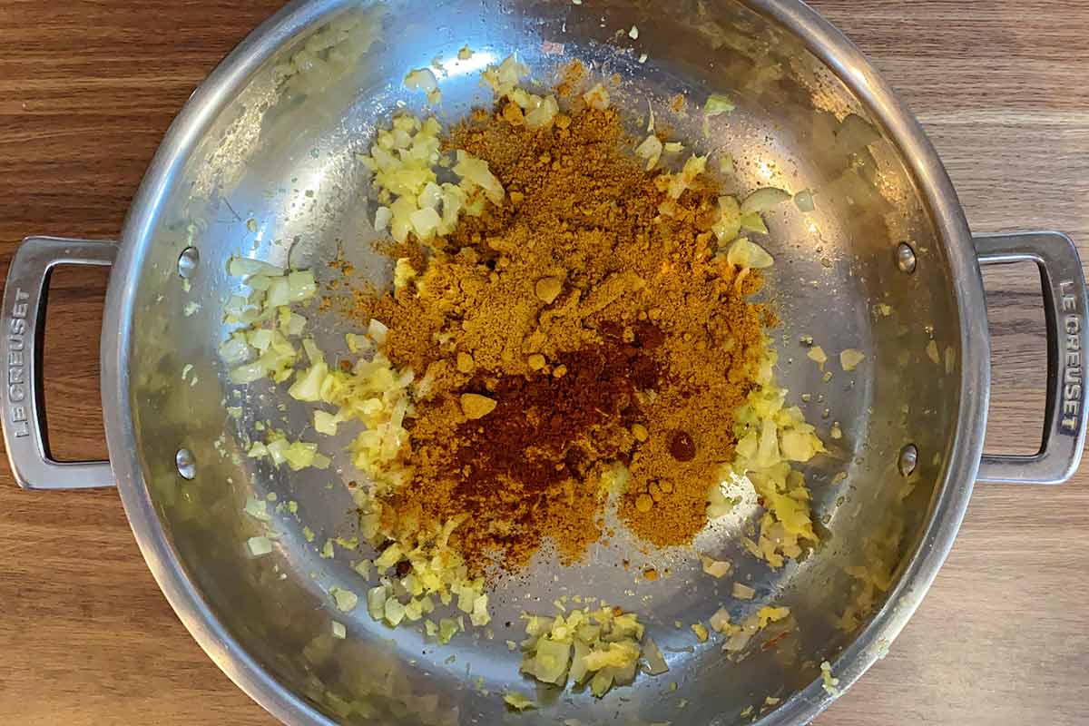 Curry powder and chilli added to the pan.