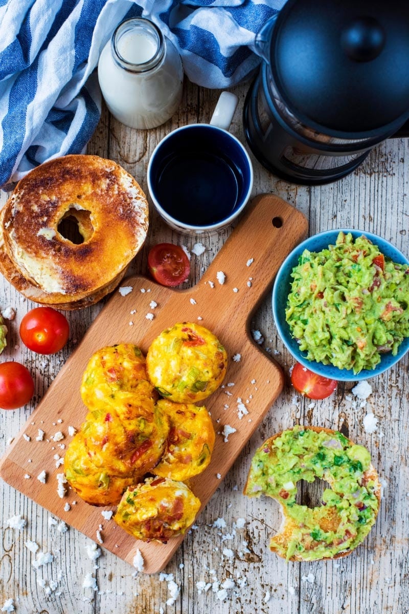 Egg Muffins on a wooden surface with tomatoes, coffee and milk.