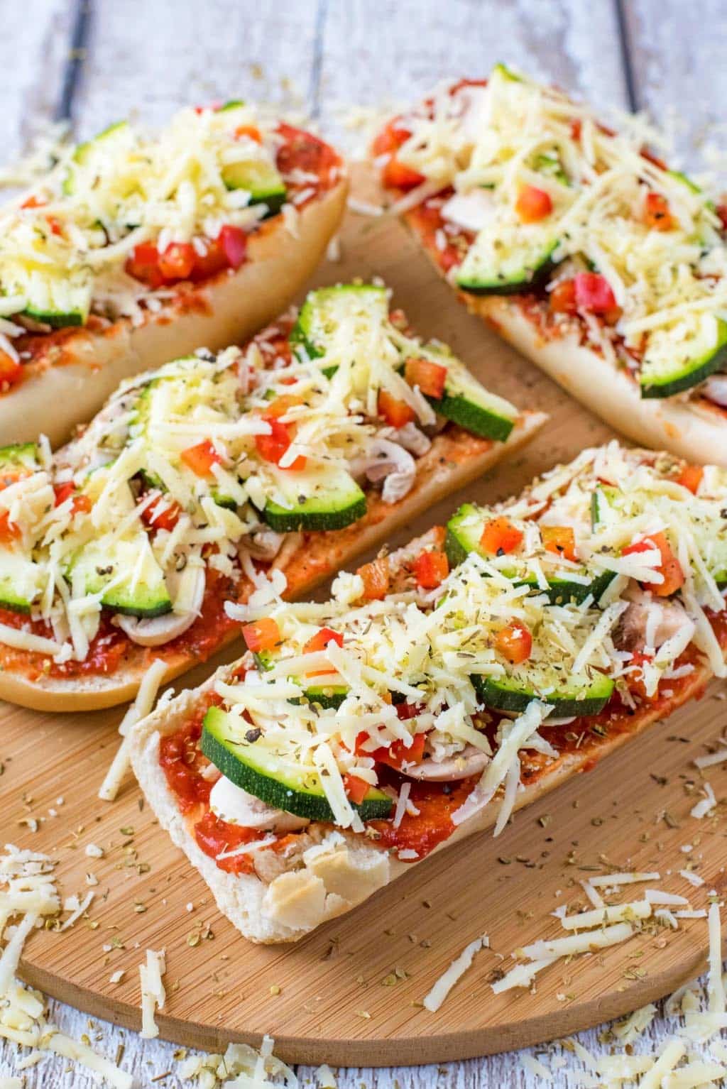 Vegetable pizzas on a serving board.