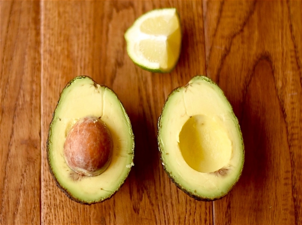 Cut avocado with a lime wedge