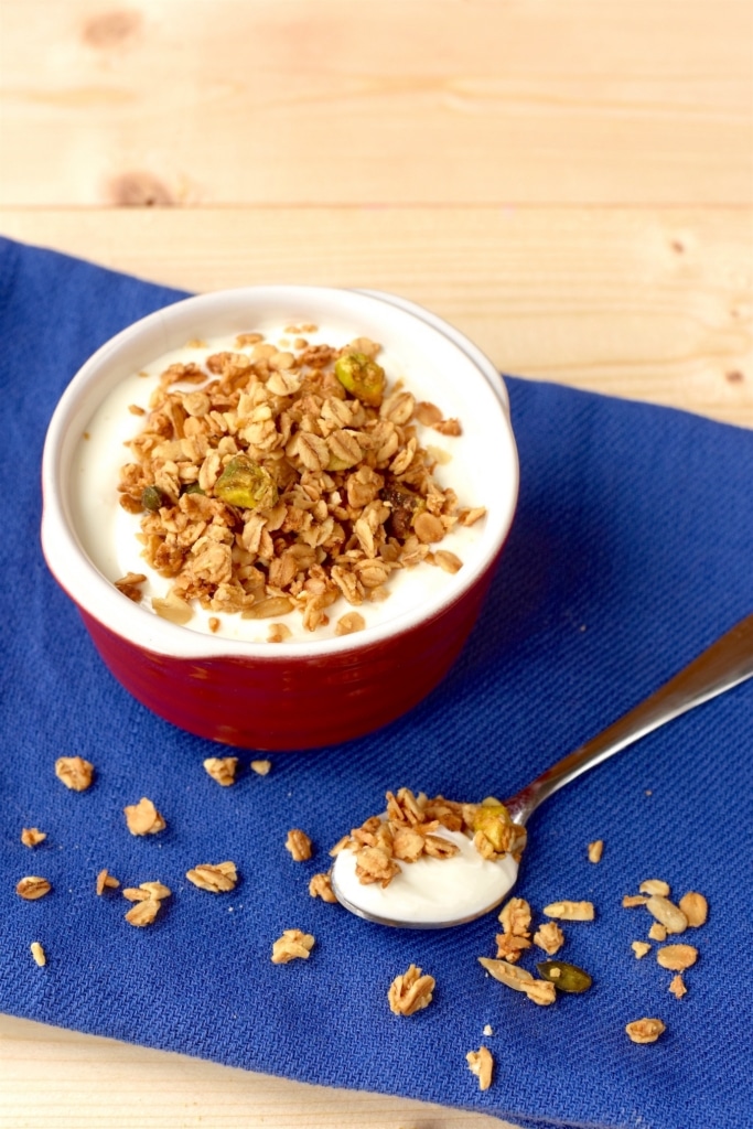 A small dish full of yogurt topped with some Granola