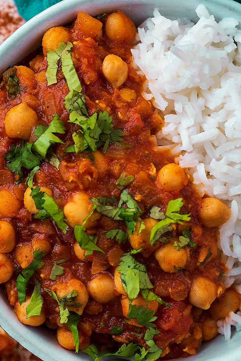 Chickpeas in a tomato sauce topped with chopped cilantro.