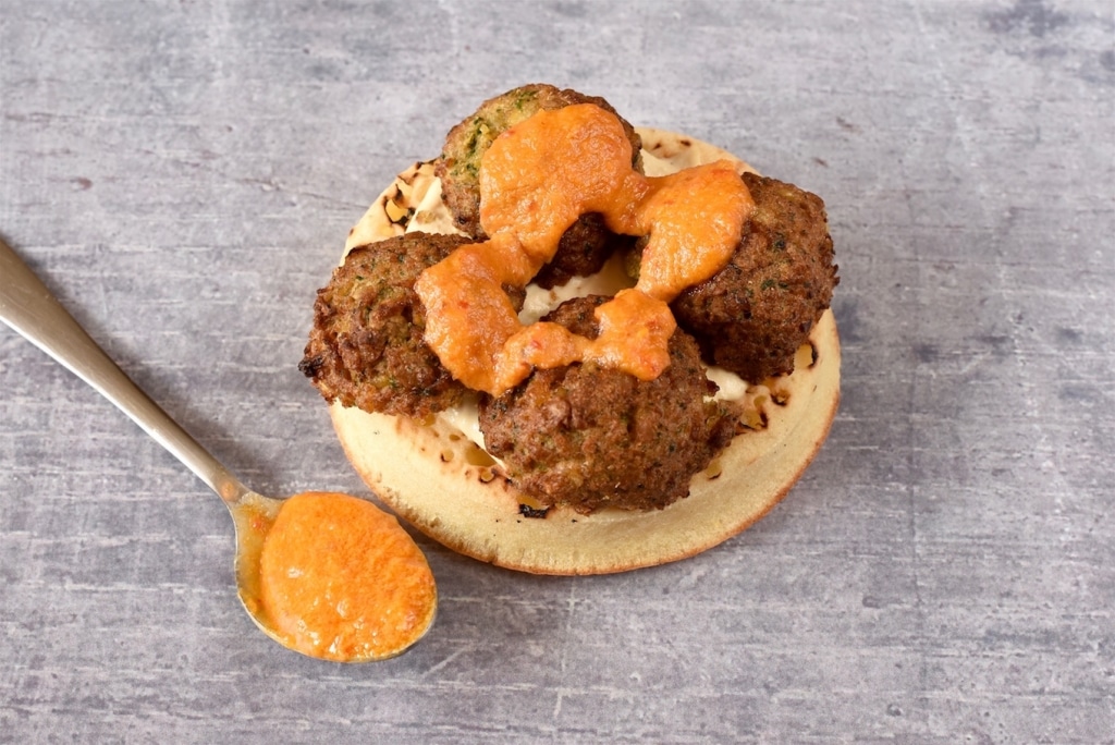 A Crumpet topped with falafel and harissa sauce