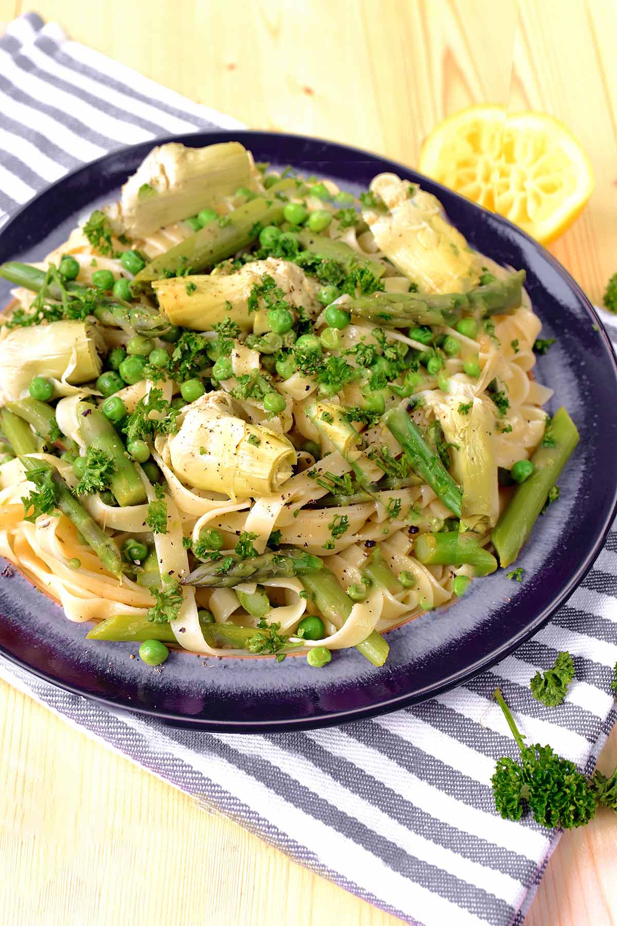 A plate of pasta mixed with green vegetables.