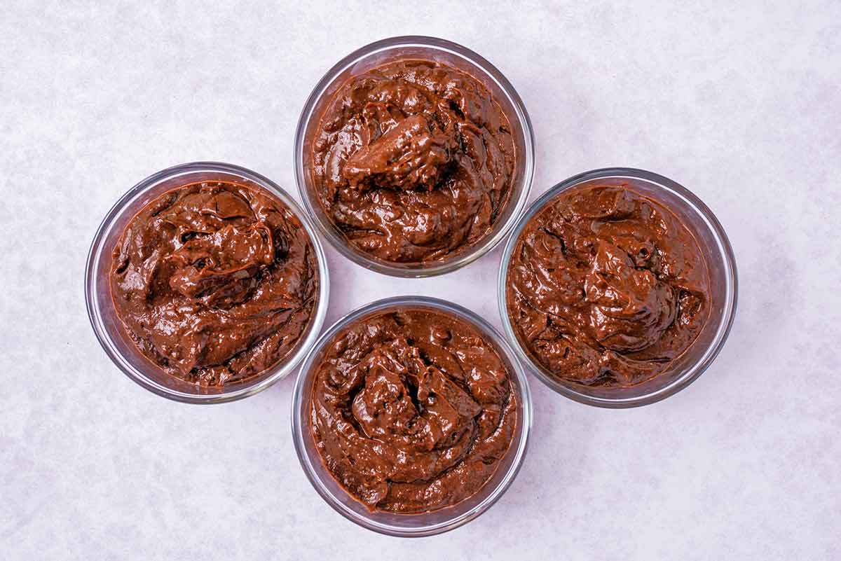 Chocolate pudding in four serving glasses.