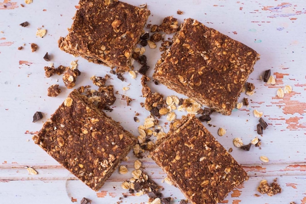No-Bake Chocolate Peanut Butter Oat Squares on a wooden surface.