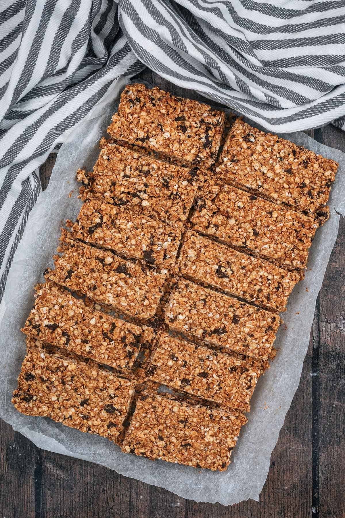 A slab of oat bar cut into twelve individual bars.