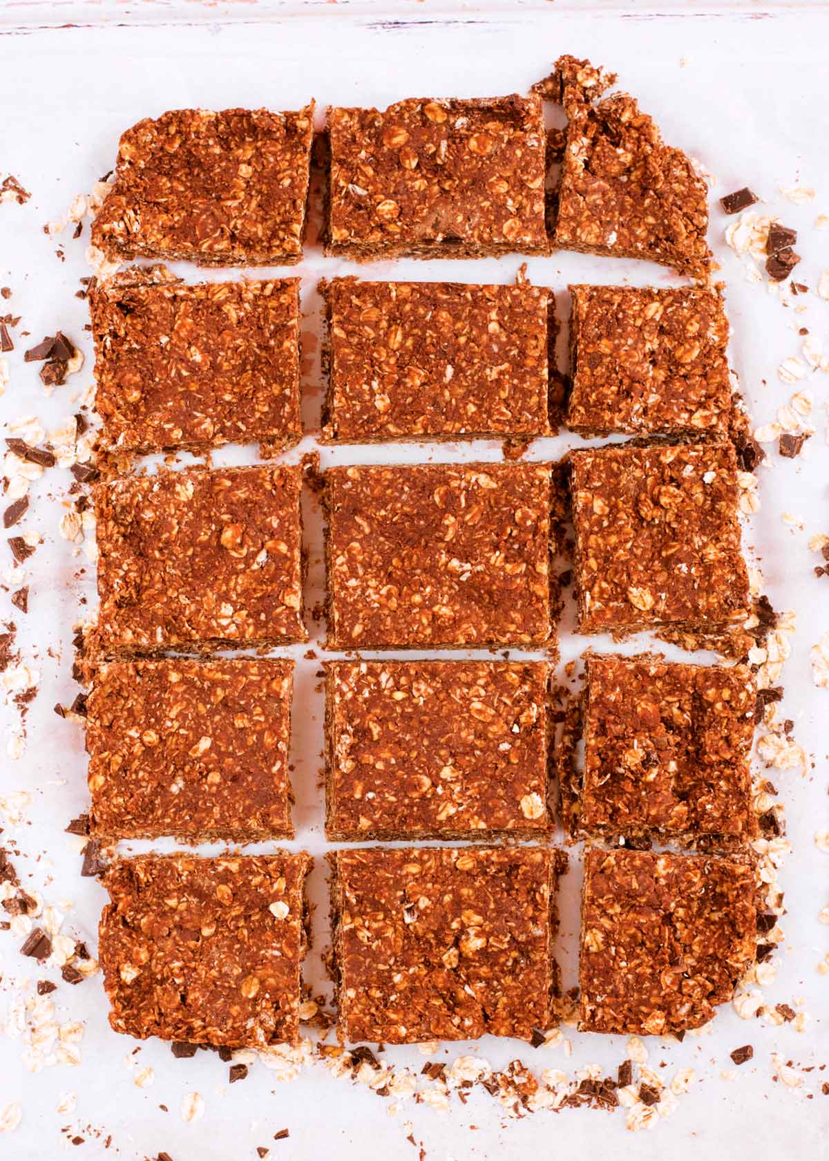 A slab of chocolate and peanut butter oats cut into squares.