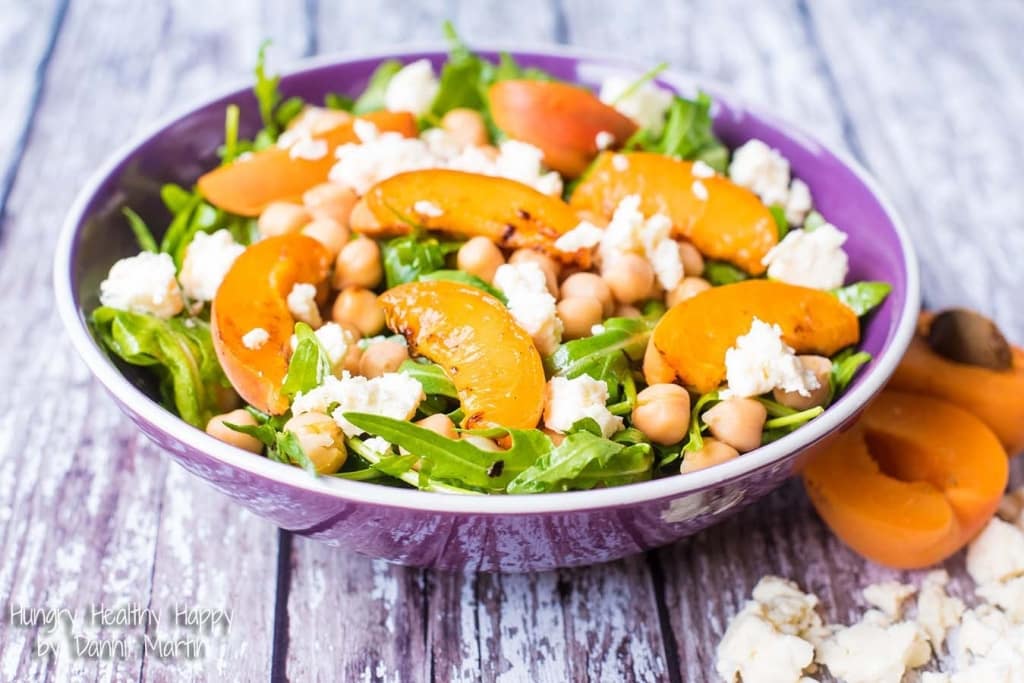 Apricot, Chickpea and Feta Salad in a purple bowl on a wooden surface.