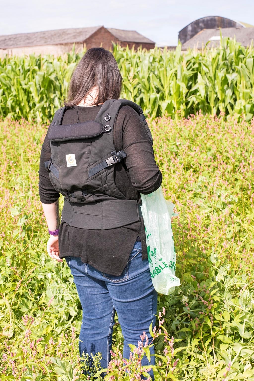 A woman in a field picking peas.