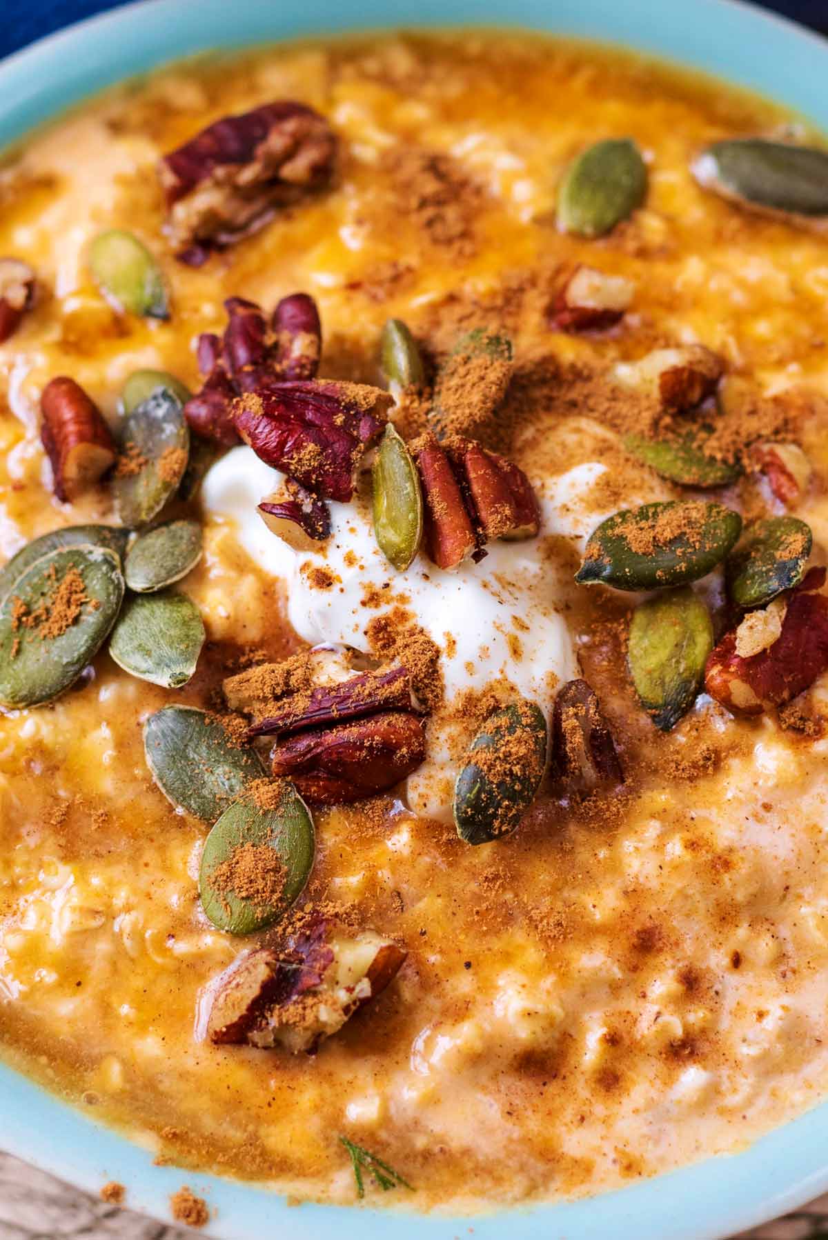 Oats topped with, pumpkin seeds, broken pecans and spices.