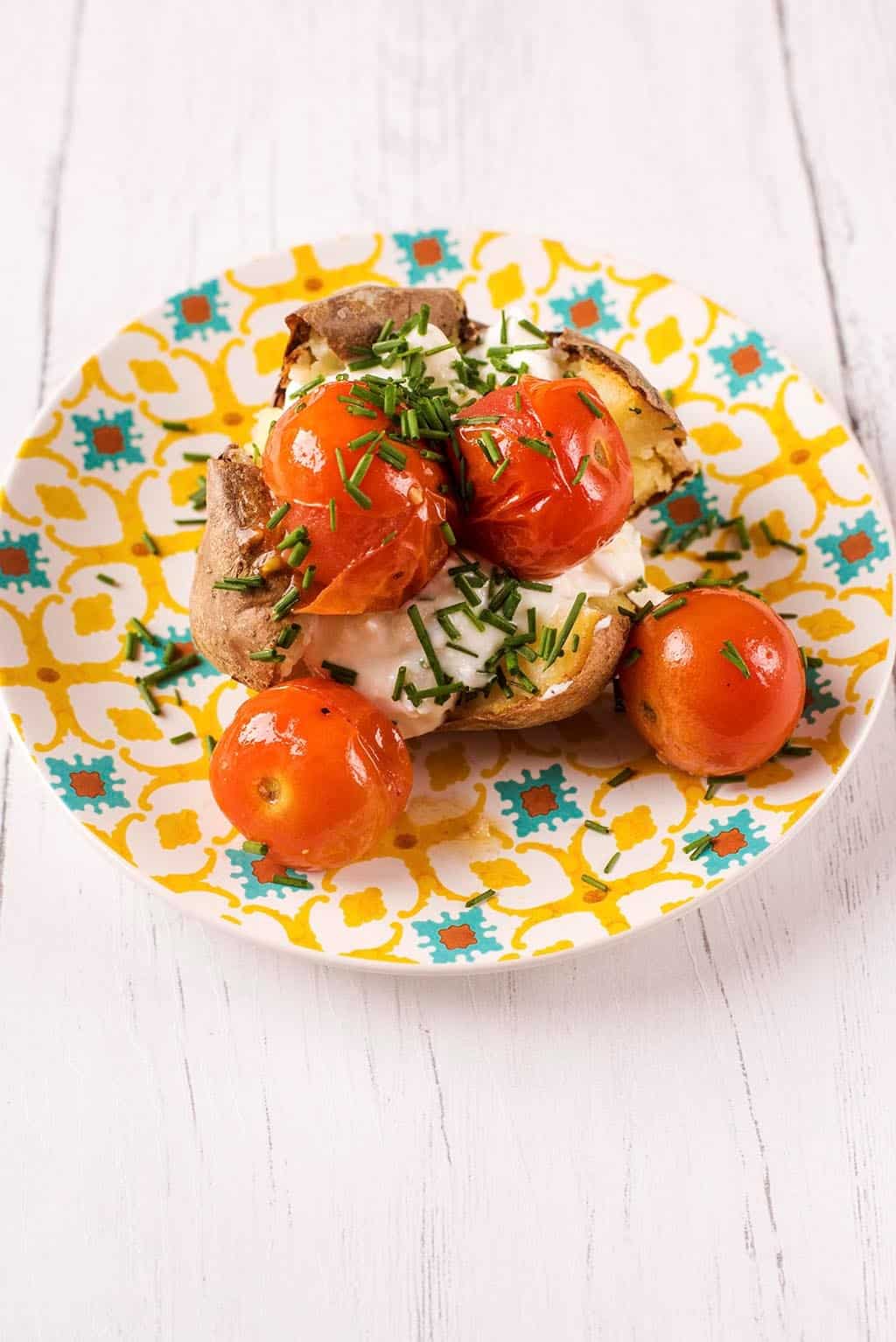 Baked Potato topped with Cottage Cheese and Roasted Cherry Tomatoes.
