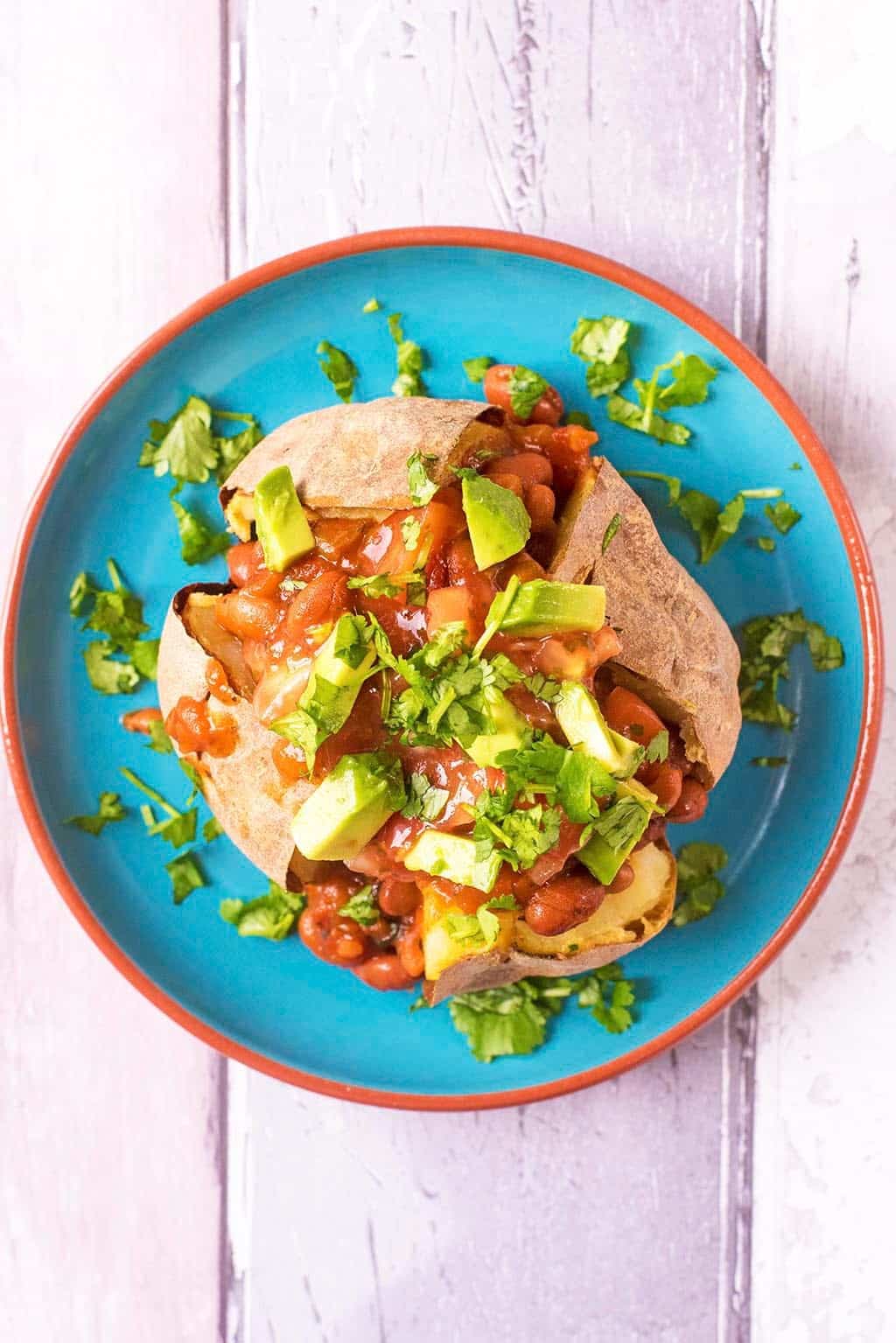 Baked Potato topped with Mexican Beans and diced Avocado.