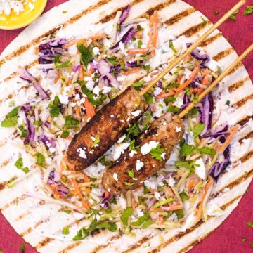 Lamb Koftas on a bed of salad on a charred wrap.