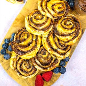 Chocolate Banana Pinwheels ona wooden serving board.