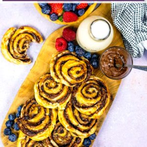 Chocolate banana pinwheels on a wooden serving board with a text title overlay.