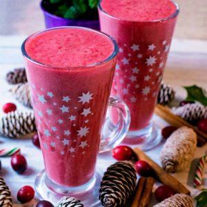 Cranberry Smoothie in a tall glass decorated with stars.