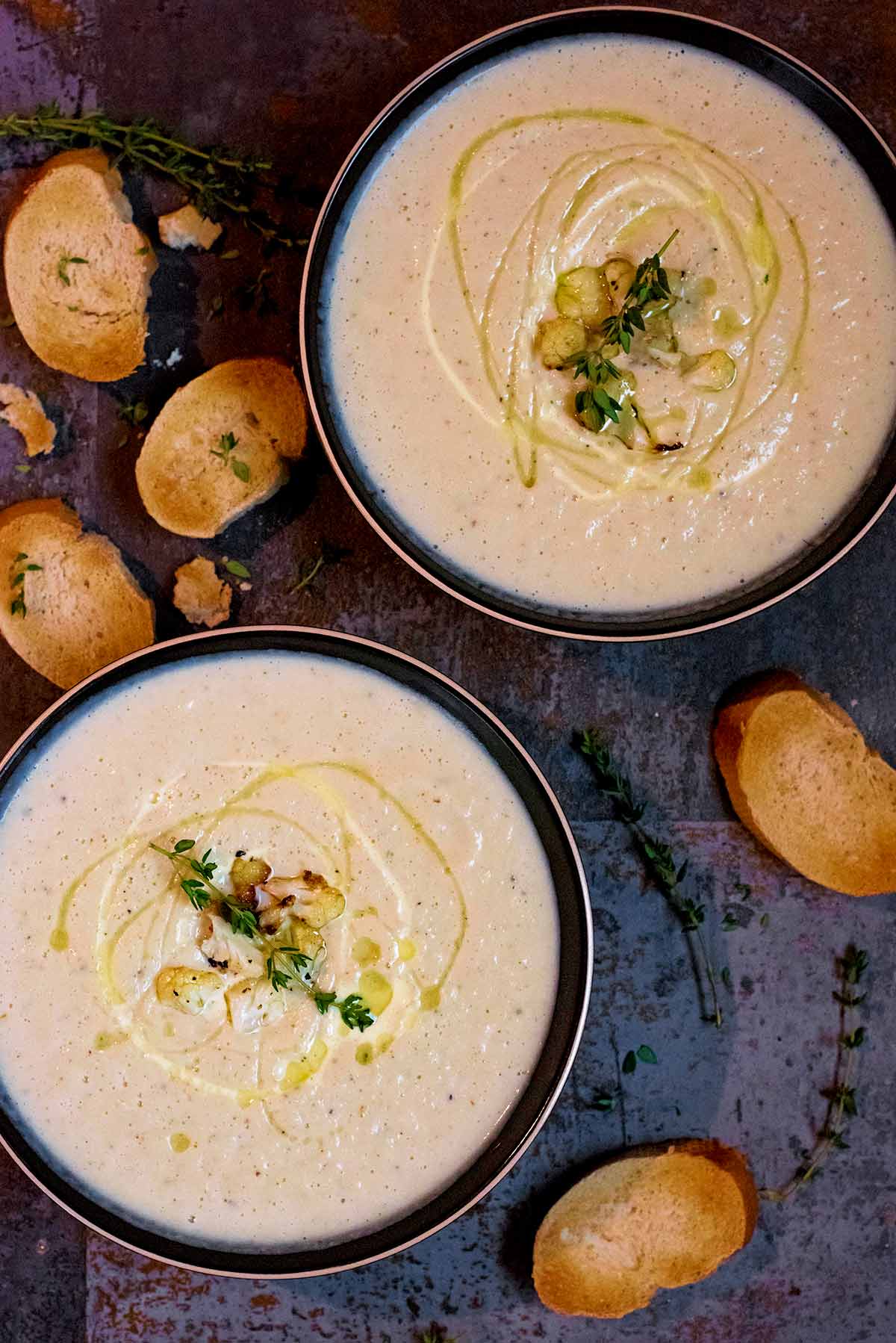 Two bowls of Creamy Roasted Cauliflower Soup.