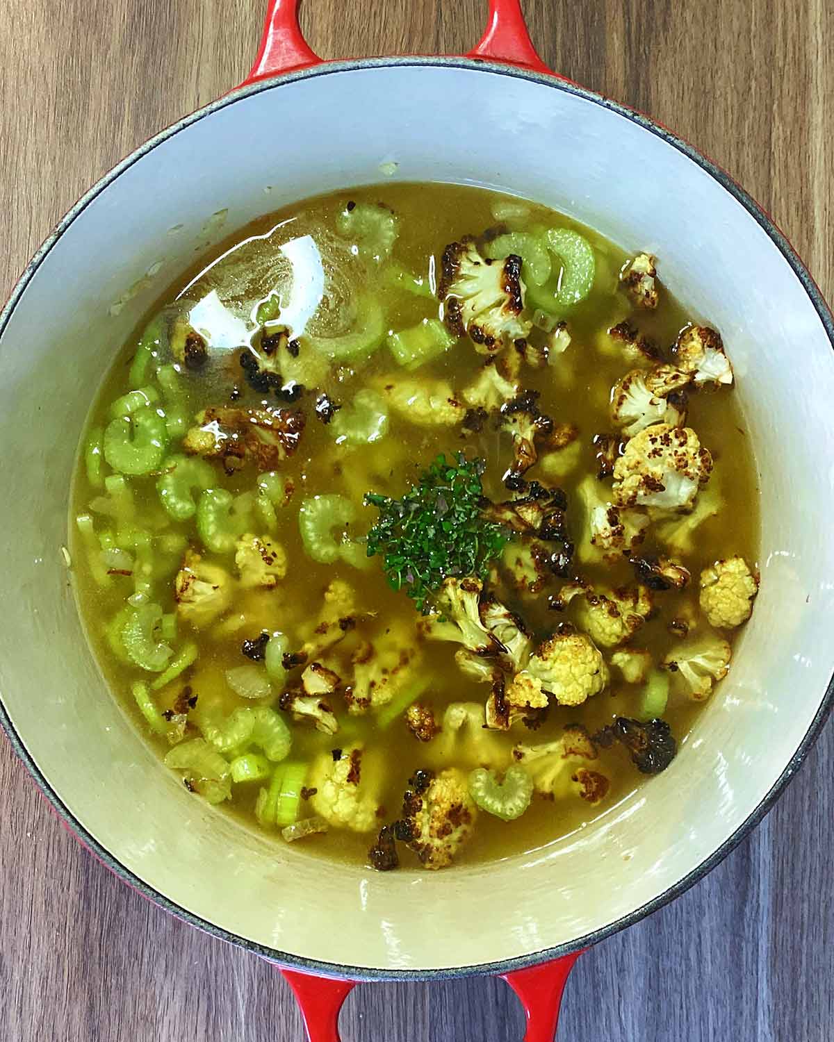 Stock and chopped thyme added to the pan.