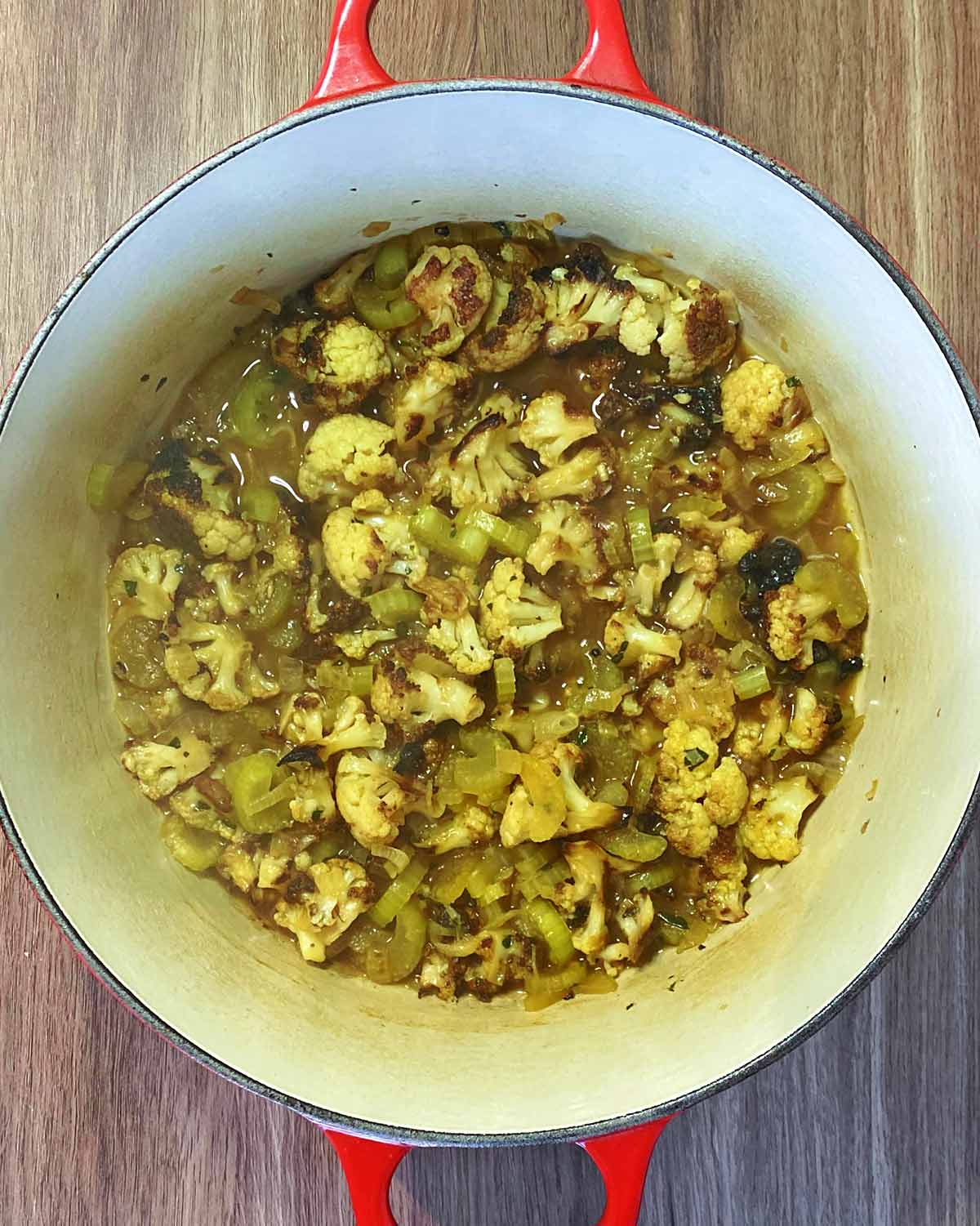 Cooked cauliflower with the stock now reduced.