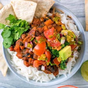 Bean Chilli on a bed of rice topped with salsa and avocado.
