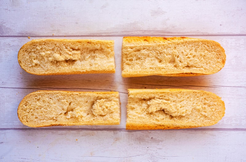 A French Bread stick cut into four long pieces.