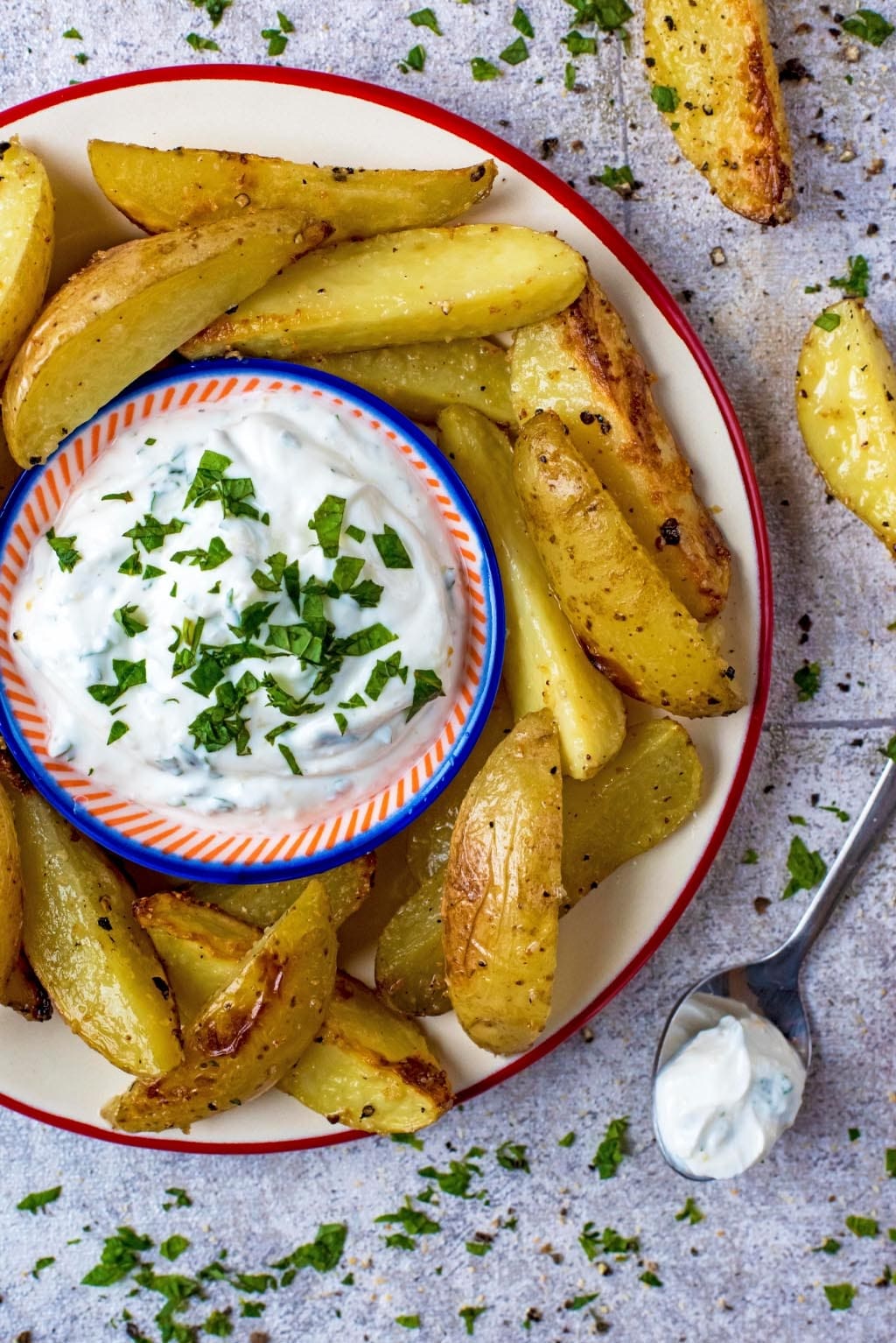 Potato Wedges and dip on a plate next to a spoonful of the dip.