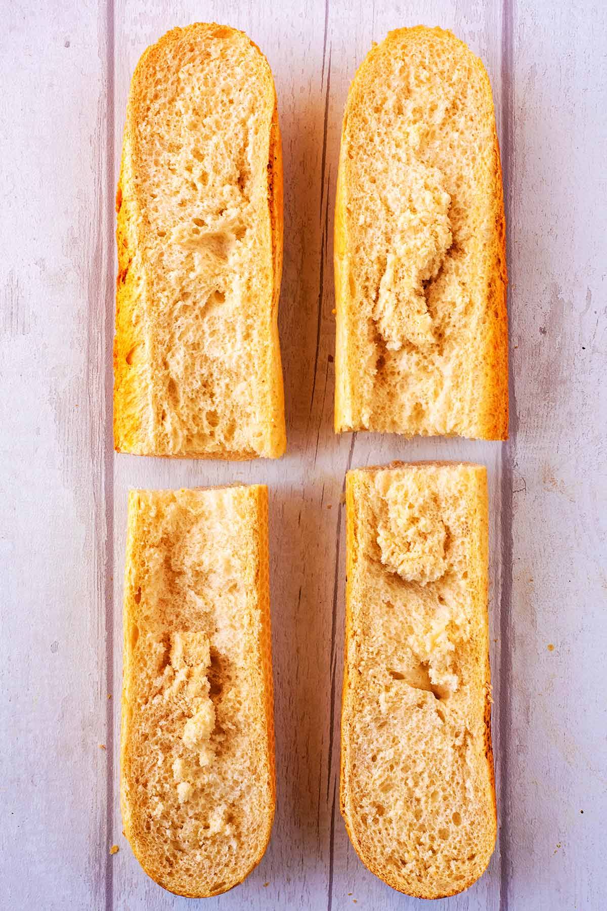 A French Bread stick cut into four long pieces.