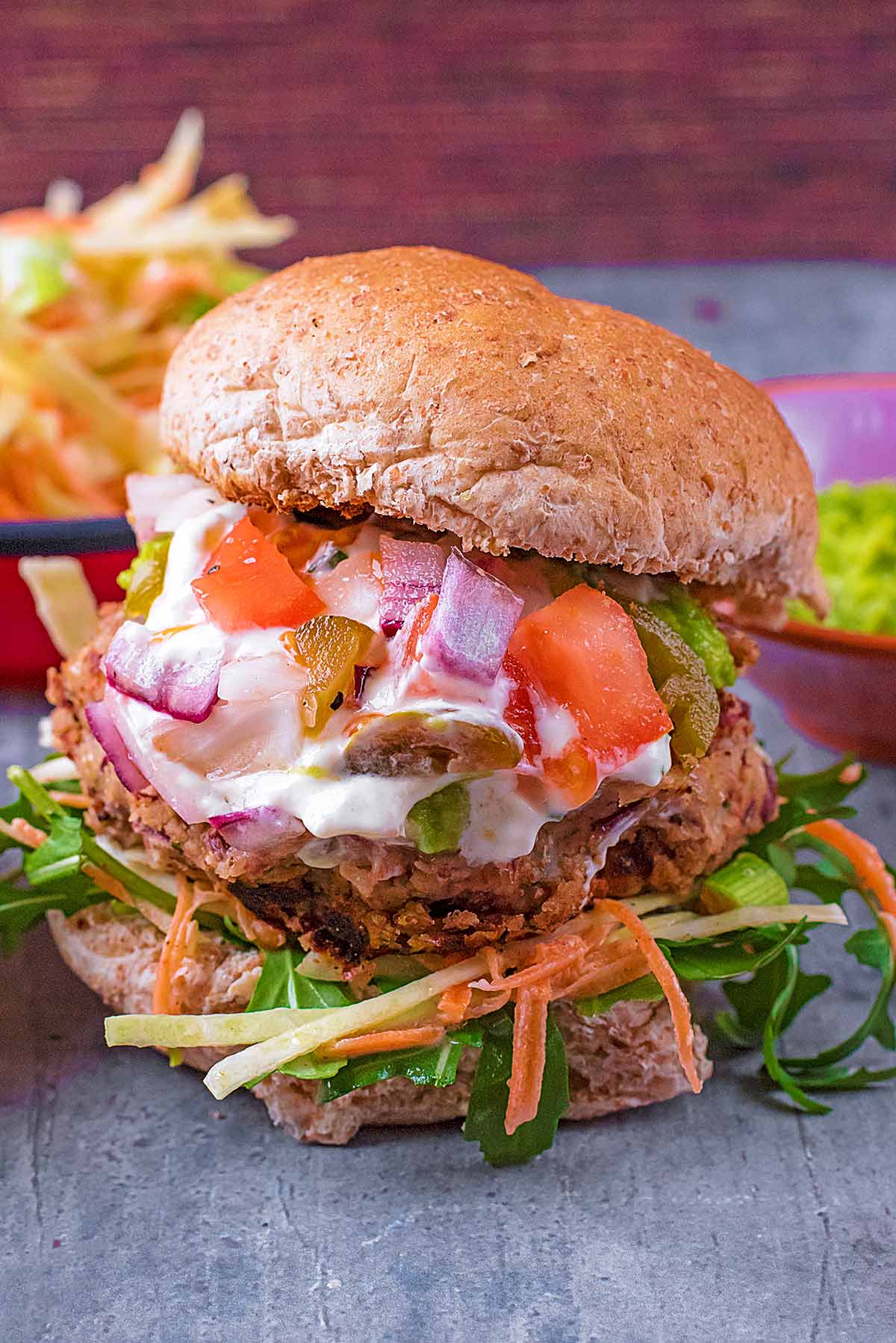 A Bean Burger with sauce and salsa spilling out.