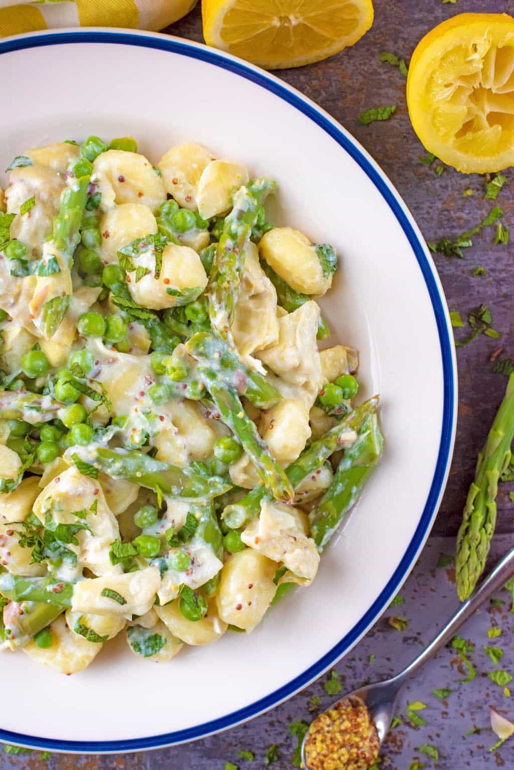 Cooked gnocchi and green vegetables in a creamy sauce.