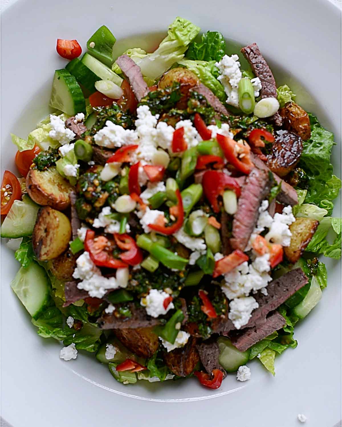 Chopped spring onions and sliced red chillies added to the top of the salad.