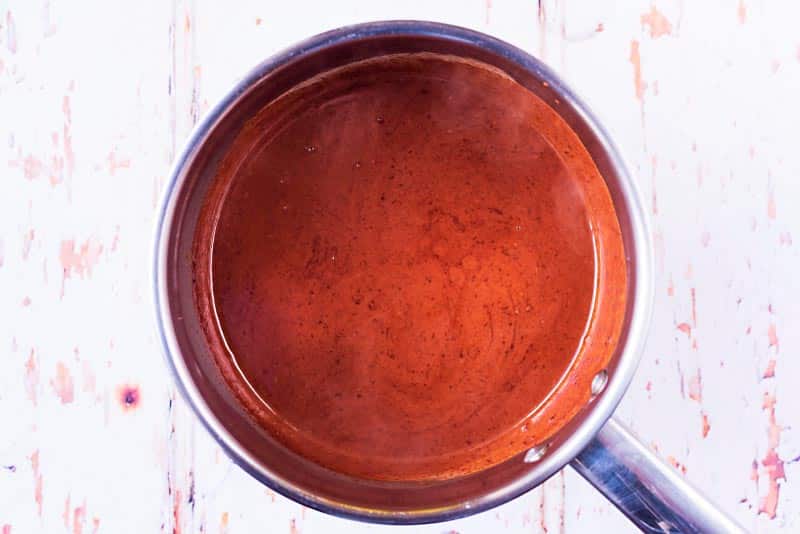 A saucepan containing a chocolate sauce.