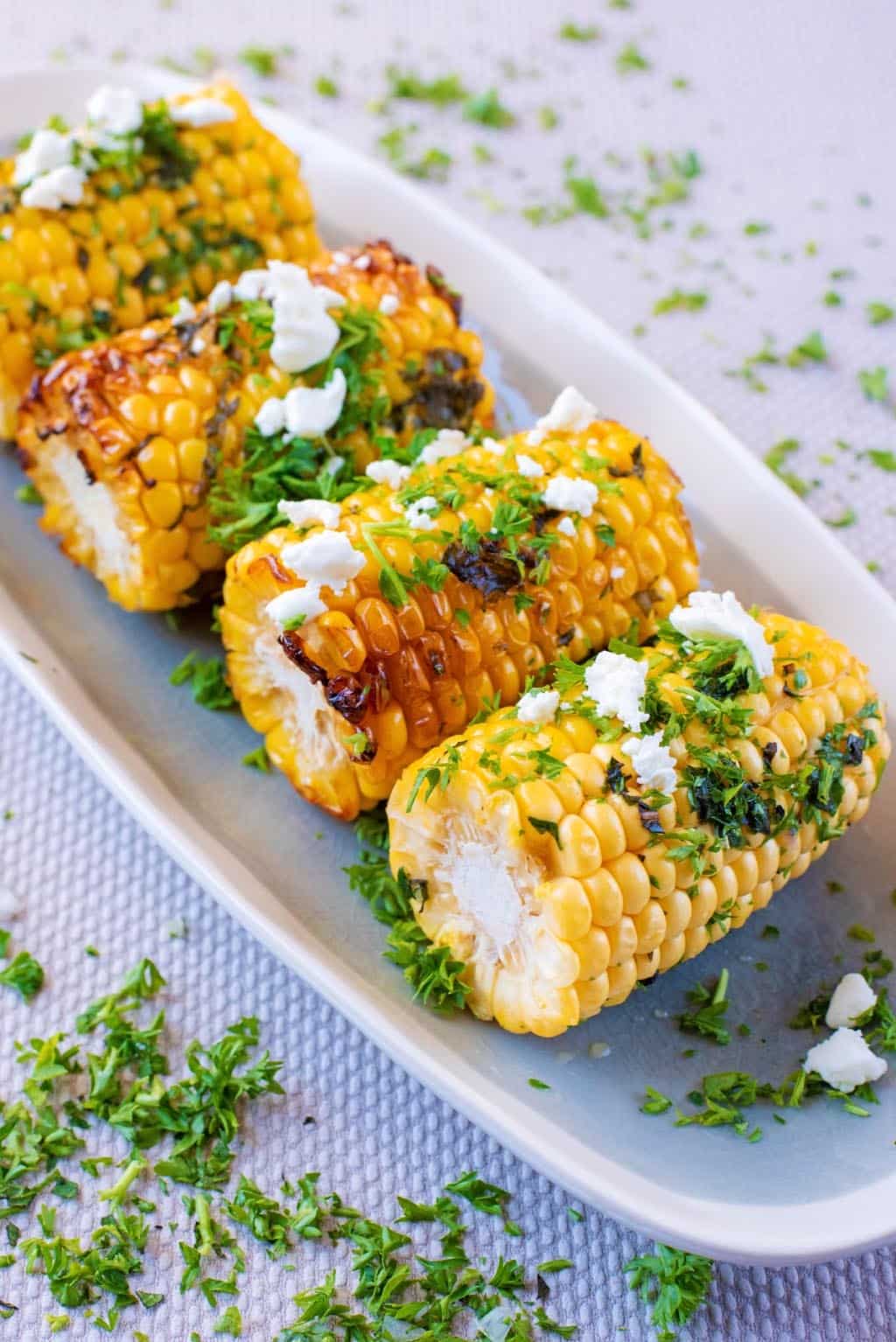 Grilled corn on the cob on a long serving dish.