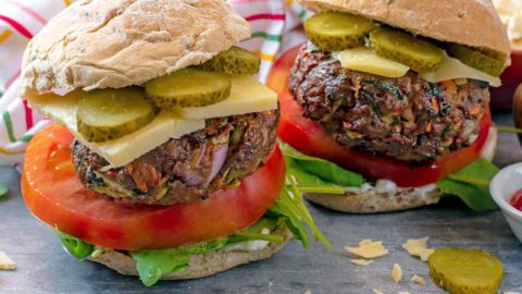 Hidden Vegetable Beef Burgers in buns with cheese, tomato and pickles.