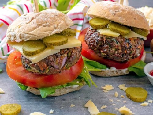 Hidden Vegetable Beef Burgers in buns with cheese, tomato and pickles.