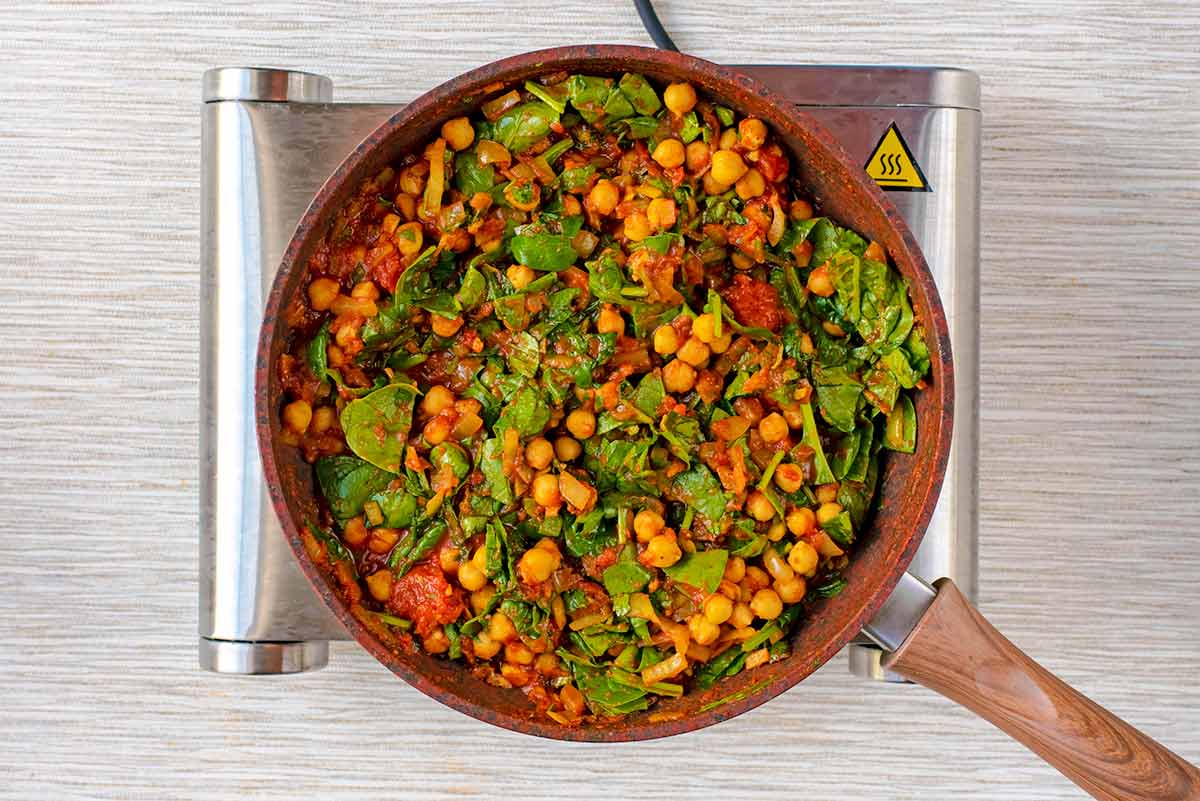 Cooked chickpea spinach curry in the pan.