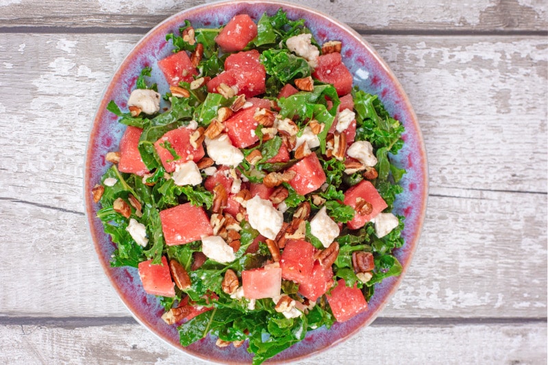 A plate of kale, watermelon and feta salad.