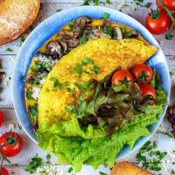 A mushroom omelette on a blue plate.