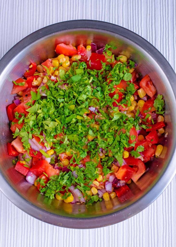 Chopped coriander and chopped jalapenos added to the bowl.