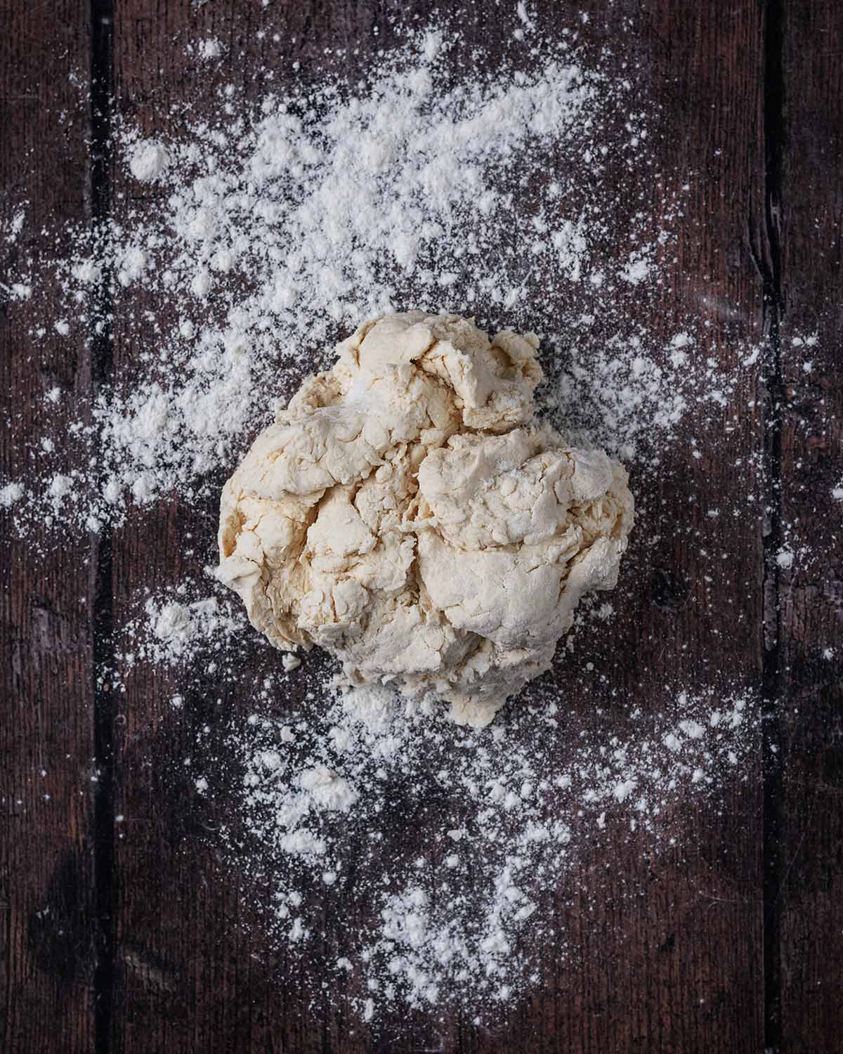 A ball of dough on a floured work surface.